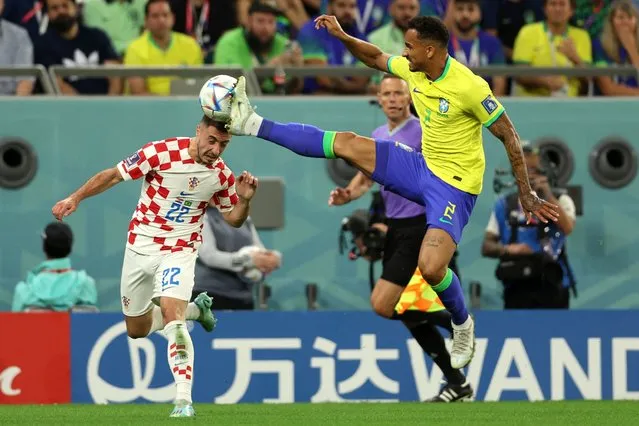 Brazil's defender #02 Danilo (R) commits a foul on Croatia's defender #22 Josip Juranovic  during the Qatar 2022 World Cup quarter-final football match between Croatia and Brazil at Education City Stadium in Al-Rayyan, west of Doha, on December 9, 2022. (Photo by Adrian Dennis/AFP Photo)