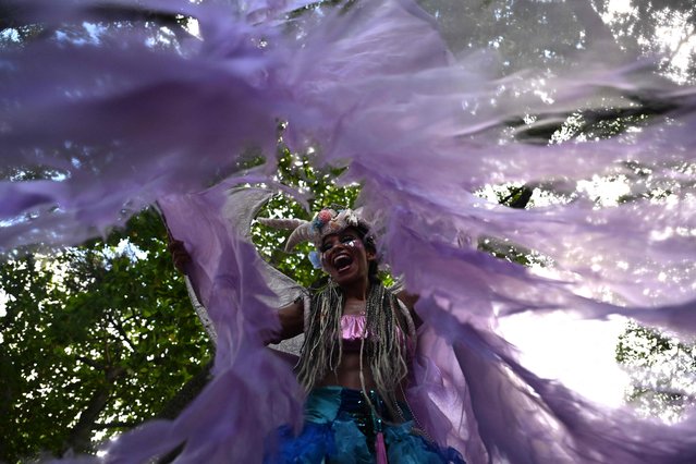 A reveler takes part in a parade of the street carnival group Loucura Suburbana (Suburban Craziness) at the Engenho de Dentro neighborhood in the suburbs of Rio de Janeiro, Brazil on February 8, 2024. The “Loucura Suburbana” street carnival group is organized by workers and patients of the Nise da Silveira Municipal Psychiatric Hospital. The parade starts inside the hospital and winds its way through the streets of the neighborhood. (Photo by Mauro Pimentel/AFP Photo)