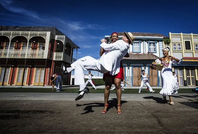 Brazilian performers Vanessa Nascimento holds Carlinhos de Jesus while dancing during the Rock in Rio USA sneak peak event, October 27, 2014, in Las Vegas. The permanent open-air concert venue sits on 37 acres with the capacity for 85,000 people per day. (Photo by Jeff Scheid/AP Photo/Las Vegas Review-Journal)