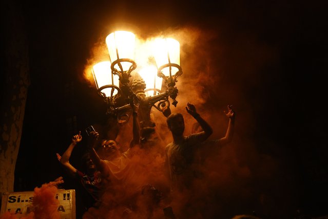 FC Barcelona's fans celebrate winning the Spanish LaLiga soccer championship at Canaletas Square in Barcelona, Spain, 15 May 2025, after  the Spanish LaLiga soccer match between RCD Espanyol and FC Barcelona at the RCDE Stadium in Cornella de Llobregat. (Photo by Quique Garcia/EPA/EFE)