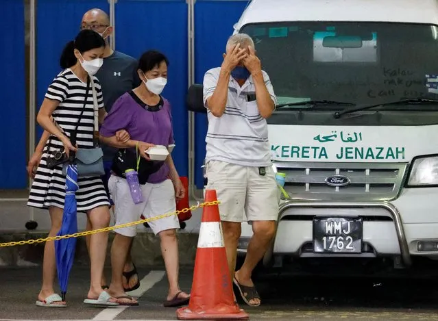 Family members of a Batang Kali, landslide victim, leave Sungai Buloh Hospital's mortuary in Sungai Buloh, Selangor, Malaysia on December 17, 2022. (Photo by Hasnoor Hussain/Reuters)