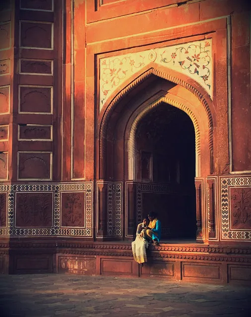 “Dusk at the Taj Mahal, and away from the tourists I noticed two friends chatting. I was drawn to their beautiful coloured clothing against the architecture”. (Photo by Stella Chidzik/The Guardian)