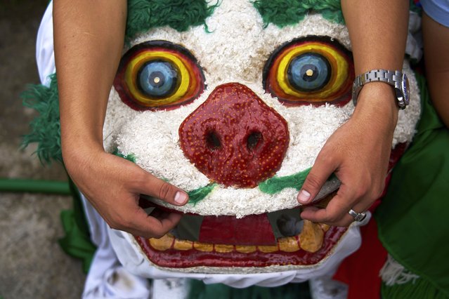 A Tibetan dance performer holds a mask while waiting for the function to start during the 90th birthday celebration of spiritual leader the Dalai Lama at the Tibetan Camp in Kathmandu, Nepal, Sunday, July 6, 2025. (Photo by Niranjan Shrestha/AP Photo)