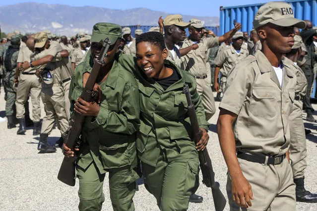 New members of the Armed Forces of Haiti celebrate after their graduation ceremony in Port-au-Prince, Haiti, Thursday, December 22, 2022. (Photo by Odelyn Joseph/AP Photo)