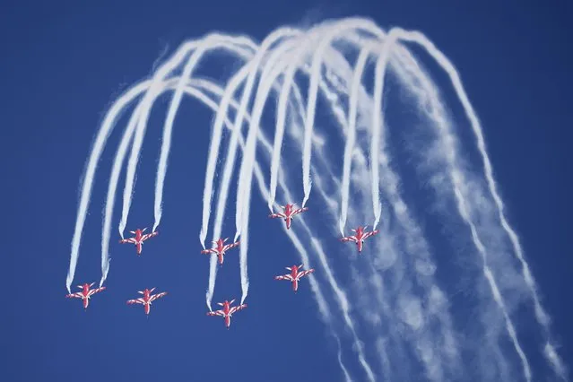 Indian Air Force's aerobatic team Suryakiran perform maneuvers on the first day of the Aero India 2023 at Yelahanka air base in Bengaluru, India, Monday, February 13, 2023. Aero India is a biennial event with flying demonstrations by stunt teams and militaries and commercial pavilions where aviation companies display their products and technology. (Photo by Aijaz Rahi/AP Photo)