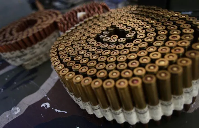 Bullets are displayed on a table during the Big Sandy Shoot in Mohave County, Arizona March 22, 2013. The Big Sandy Shoot is the largest organized machine gun shoot in the United States attended by shooters from around the country. Vintage and replica style machine guns and cannons are some of the weapons displayed during the event. Picture taken March 22, 2013. (Photo by Joshua Lott/Reuters)