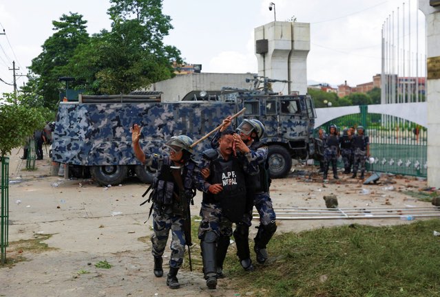 A riot police officer is taken to the hospital after being injured during a protest against corruption and the government’s decision to block several social media platforms, outside the parliament in Kathmandu, Nepal on September 8, 2025. (Photo by Navesh Chitrakar/Reuters)