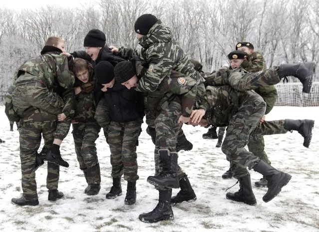 Students from the General Yermolov Cadet School take part in the so-called “wall to wall” traditional fighting game in Stavropol, southern Russia, December 6, 2014. The General Yermolov Cadet School in Stavropol is a state-run institution that teaches military and patriotic classes in addition to a normal syllabus. (Photo by Eduard Korniyenko/Reuters)