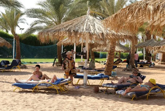 Tourists sunbath by the beach in the Red Sea resort of Sharm el-Sheikh, November 7, 2015. (Photo by Asmaa Waguih/Reuters)