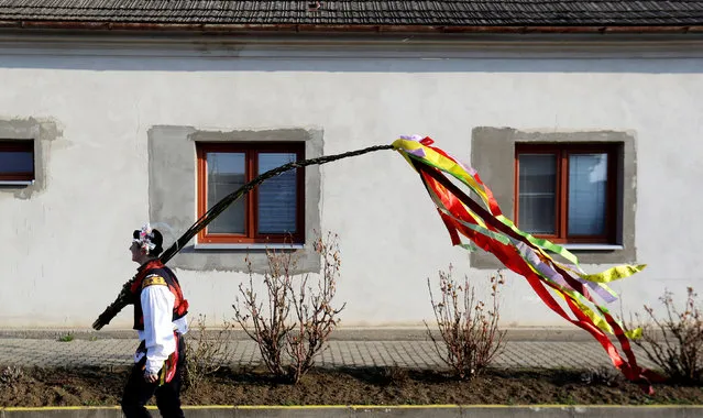 A man wearing a traditional costume carries a willow stick during Easter celebrations in Stare Mesto, Czech Republic, April 2, 2018. (Photo by David W. Cerny/Reuters)