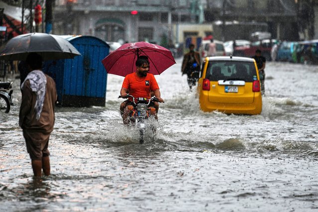 Motorists drive through a flooded road during monsoon rainfall, in Rawalpindi, Pakistan, Thursday, July 17, 2025. (Photo by Anjum Naveed/AP Photo)