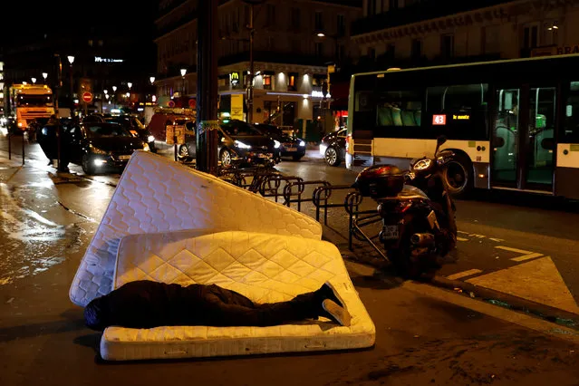 A man sleeps on a matress next to the SCMR (Drug supervised injection site), the first supervised injection room for drug users, in Paris, France, October 17, 2016. (Photo by Benoit Tessier/Reuters)