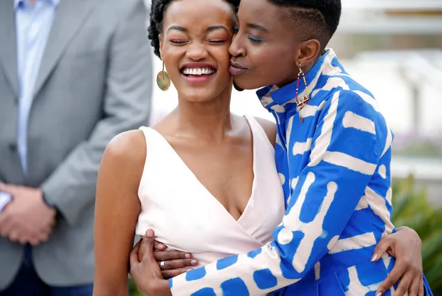 (L-R) Actress Sheila Munyiva is kissed by actress Samantha Mugatsia attend the photocall for “Rafiki” during the 71st annual Cannes Film Festival at Palais des Festivals on May 9, 2018 in Cannes, France. (Photo by Stephane Mahe/Reuters)