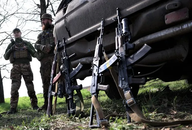 Artillerymen of Ukrainian 80th separate airborne assault brigade rest their rifles against their car on the front line near Bakhmut in Donetsk region on April 18, 2023, amid the Russian invasion of Ukraine. (Photo by Anatolii Stepanov/AFP Photo)