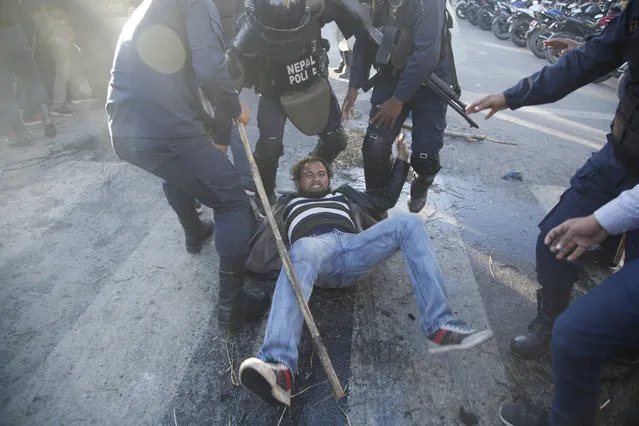 A Nepalese supporter of the splinter group in the governing Nepal Communist Party falls during clashes with police in Kathmandu, Nepal, Thursday, January 7, 2021. Nepal's president dissolved Parliament after the prime minister recommended the move amid an escalating feud within his Communist Party that is likely to push the Himalayan nation into a political crisis. (Photo by Niranjan Shrestha/AP Photo)