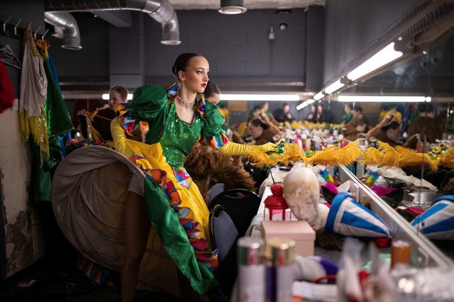 Dancers prepare in their dressing room backstage to perform in the Christmas pantomime “Dick Whittington” at St Helens Theatre Royal in St Helens, north-west England on December 10, 2025. Built by architect Frank Matcham in the 19th Century, the Theatre Royal is the principal theatre in St Helens with 700 seats over two tiers. The production of 'Dick Whittington' is set to run until mid-January. Across the country over the festive season, children and adults alike flock to theatres to watch a traditional British Christmas “panto” – complete with princesses, political jibes, innuendo and a dame. (Photo by Oli Scarff/AFP via Getty Images)