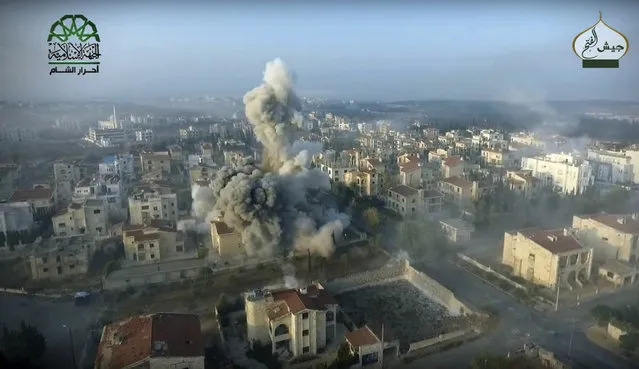 This still image taken from drone footage, posted online by the communications arm of Ahrar al-Sham militant group, purports to show a blast on the ground, apparently the result of an airstrike, in an Assad neighborhood of Aleppo, Syria. Syrian government forces launched a counteroffensive Saturday, October 29, 2016, under the cover of airstrikes in an attempt to regain control of areas they had lost to insurgents the day before in the northern city of Aleppo, activists and state media said. (Photo by Ahrar al-Sham, militant video, via AP Photo)
