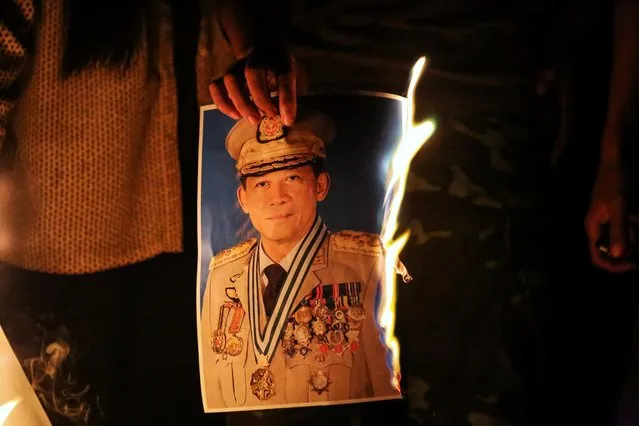 People burn a portrait of Army chief General Min Aung Hlaing as they protest against the military coup, in Mandalay, Myanmar on February 3, 2021. (Photo by Reuters/Stringer)
