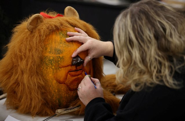 Artist Natasha Brown paints the face of the Cowardly Lion from the film “The Wizard of Oz” on a pumpkin in the workshop of creative group Sand In Your Eye ahead of the annual pumpkin trail in Hebden Bridge, Britain on October 16, 2024. (Photo by Phil Noble/Reuters)