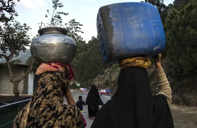 Women carry water as they walk on Margalla Hills in Islamabad January 22, 2015. (Photo by Zohra Bensemra/Reuters)