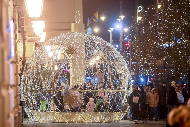 People visit the Christmas market in Debrecen, Hungary, 22 December 2024. Security measures were strengthened around the Christmas markets in Hungary after a man drove his car into a crowd at a Christmas market in Magdeburg, Germany on 20 December. (Photo by Zsolt Czegledi/EPA/EFE)
