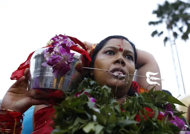 A Hindu devotee is seen on her pilgrimage to the Batu Caves temple during Thaipusam in Kuala Lumpur February 3, 2015. Hindu devotees across Malaysia on Tuesday celebrated Thaipusam, a religious celebration dedicated to the Hindu deity Lord Murugan. (Photo by Olivia Harris/Reuters)