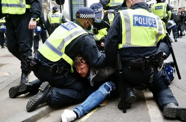 Police take measures around the site as people gather to stage a demonstration to protest against the ongoing restrictions against the novel coronavirus (Covid-19), in London, United Kingdom on March 20, 2021. In the demonstration held despite the ban, police officers intervened in front of the BBC and detained some of protestors. (Photo by Hasan Esen/Anadolu Agency via Getty Images)