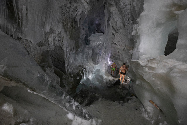Ice swimmer Josef (L) and Rene (R) on their way through the newly discovered “Ice Cathedral” to swim in a filled up water kettle in an ice cave inside the Nature Ice Palace, with a hight of 3,250 meters (10,663 feet) above sea level, at Hintertux Glacier near Hintertux, some 480 kilometers (298 miles) western of Vienna, Austria, 27 July 2018. (Photo by Christian Bruna/EPA/EFE)