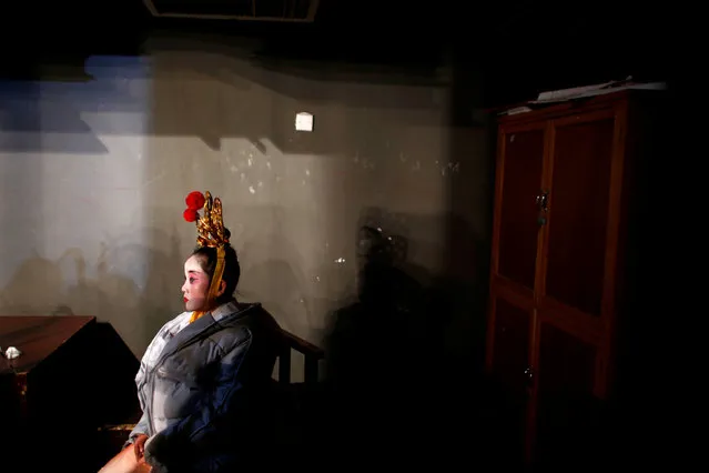 A participant waits for her turn backstage during a traditional Chinese opera competition at the National Academy of Chinese Theatre Arts in Beijing, China, November 26, 2016. (Photo by Thomas Peter/Reuters)