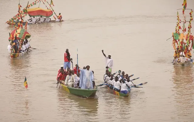 Baaba Maal makes his entrance aboard a fishing boat. (Photo by Andy Hall/The Observer)