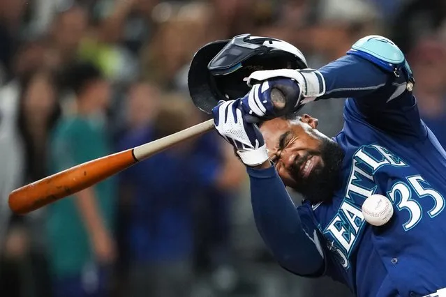 Seattle Mariners' Teoscar Hernandez is hit by a pitch from San Diego Padres reliever Steven Wilson during the eighth inning of a baseball game Wednesday, August 9, 2023, in Seattle. (Photo by Lindsey Wasson/AP Photo)