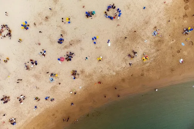 Israelis enjoy the beach of the Mediterranean during a heat wave as coronavirus disease (COVID-19) restrictions ease around the country, in Ashkelon Israel April 19, 2021. Picture taken with a drone. (Photo by Amir Cohen/Reuters)