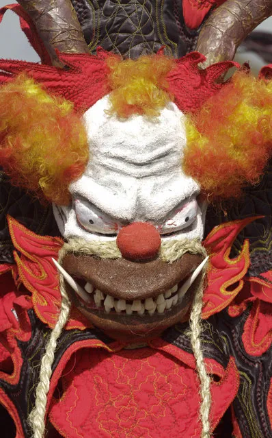 A man dressed in a devil costume with a scary clown face takes part in the Devils and Congos carnival ritual, in Nombre de Dios, Panama, Wednesday, February 18, 2015. (Photo by Arnulfo Franco/AP Photo)