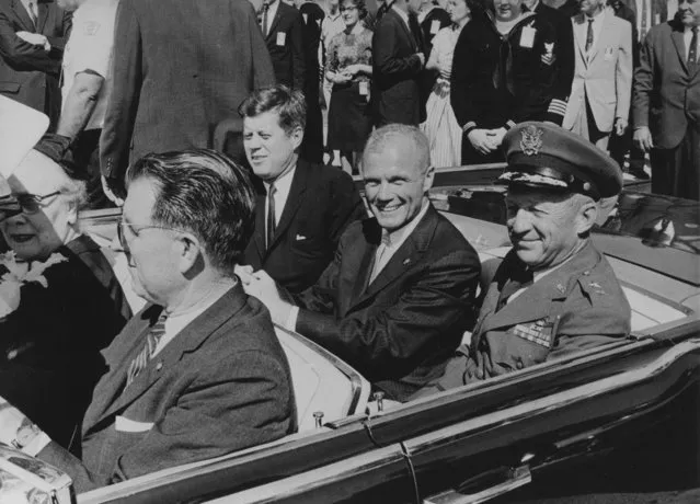 President John F. Kennedy (left), John Glenn (center) and General Leighton I. Davis (right) ride together in the back seat during a parade in Cocoa Beach, Florida after Glenn piloted the country's first human orbital spaceflight. (Photo by AP Photo)