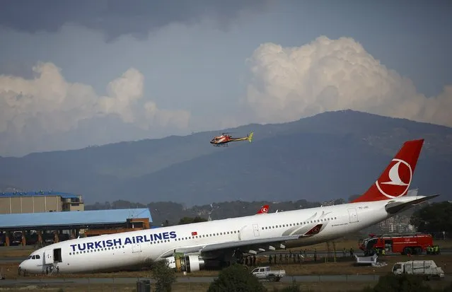 A Turkish Airlines plane lies on a field after it overshot the runway at Tribhuvan International Airport in Kathmandu March 4, 2015. According to local media, all passengers and crew members were rescued. REUTERS/Navesh Chitrakar 