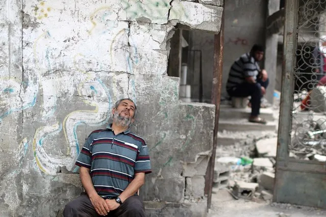 A Palestinian man rests after returning to his damaged house following Israel- Hamas truce, in Beit Hanoun in the northern Gaza Strip, May 21, 2021. (Photo by Mohammed Salem/Reuters)