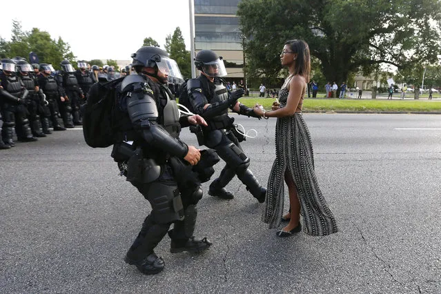 Protester Ieshia Evans is detained by law enforcement near the headquarters of the Baton Rouge Police Department in Baton Rouge, Louisiana, during a demonstration against the shooting death of Alton Sterling July 9, 2016. (Photo by Jonathan Bachman/Reuters)