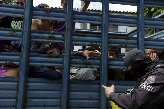People wait to be transported to a detention facility after they were detained on the suspicion of being collaborators with a street gangs, during a night raid in Apopa, on the outskirts of San Salvador, September 22, 2015. (Photo by Jose Cabezas/Reuters)