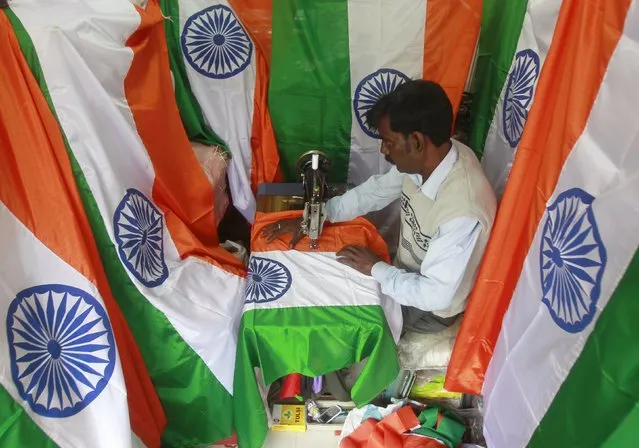 A tailor makes Indian national flags ahead of the Republic Day celebrations in Agartala, India, January 18, 2016. India celebrates its annual Republic Day on January 26. (Photo by Jayanta Dey/Reuters)