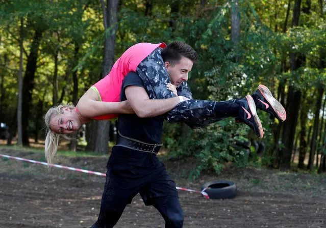 Participiants compete in Hungary's first wife-carrying championship in Tapiobicske, Hungary, October 3, 2020. (Photo by Bernadett Szabo/Reuters)