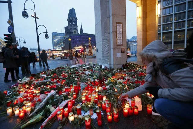 Flowers and candles are placed near the Christmas market at Breitscheid square in Berlin, Germany, December 22, 2016, following an attack by a truck which ploughed through a crowd at the market on Monday night. (Photo by Fabrizio Bensch/Reuters)