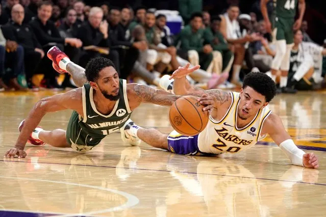 Milwaukee Bucks guard Cameron Payne, left, and Los Angeles Lakers guard Scotty Pippen Jr. go after a loose ball during the second half of an NBA preseason basketball game Sunday, October 15, 2023, in Los Angeles. (Photo by Mark J. Terrill/AP Photo)