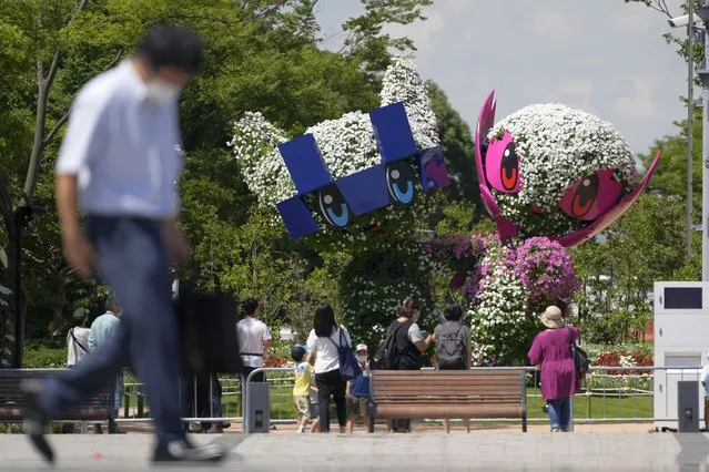 Large topiary of Miraitowa, the official mascot of Tokyo 2020 Olympics and Someity, the official mascot of Paralympics, are displayed at a Symbol Promenade Park Flower Plaza Wednesday, July 21, 2021, in Tokyo. (Photo by Kiichiro Sato/AP Photo)