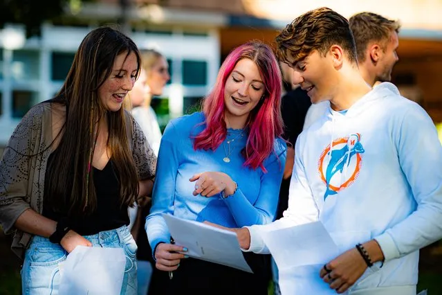 Students react as they share their results with their friends at Taunton School in Somerset, United Kingdom as students receive their A-Level results on Tuesday, August 10, 2021. (Photo by Ben Birchall/PA Images via Getty Images)
