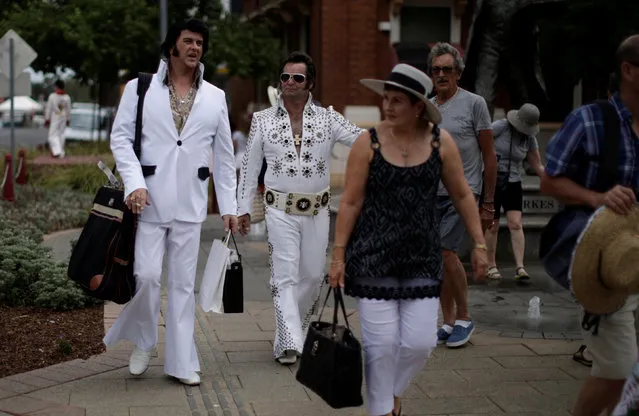 A pair of Elvis Presley impersonators walk down the main street during the 25th annual Parkes Elvis Festival in the rural Australian town of Parkes, west of Sydney, Australia January 13, 2017. (Photo by Jason Reed/Reuters)
