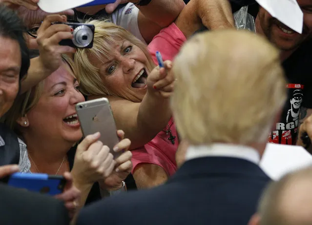People react while meeting Republican presidential candidate Donald Trump at a campaign rally Monday, February 22, 2016, in Las Vegas. (Photo by John Locher/AP Photo)