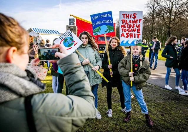 Dutch students display protest placards during a rally to claim for urgent measures to combat climate change, during a demonstration in The Hague, the Netherlands, 07 February 2019. (Photo by Remko de Waal/EPA/EFE)