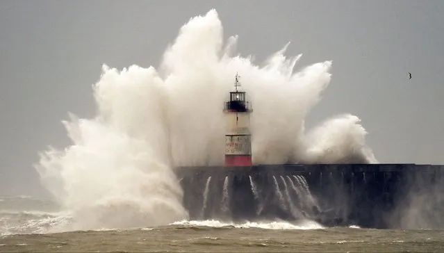 Waves crash over Newhaven Lighthouse and the harbour wall in Newhaven, southern England on February 18, 2022, as Storm Eunice brings high winds across the country. Britain put the army on standby Friday and schools closed as forecasters issued two rare “red weather” warnings of “danger to life” from fearsome winds and flooding due to the approaching storm Eunice. (Photo by Glyn Kirk/AFP Photo)