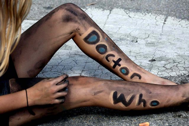 Alee Harrison, 13, wears the tv series “Doctor Who” on her legs as she works on a painting for Operation Blue Pride. (Photo by Greg Lovett/The Palm Beach Post)