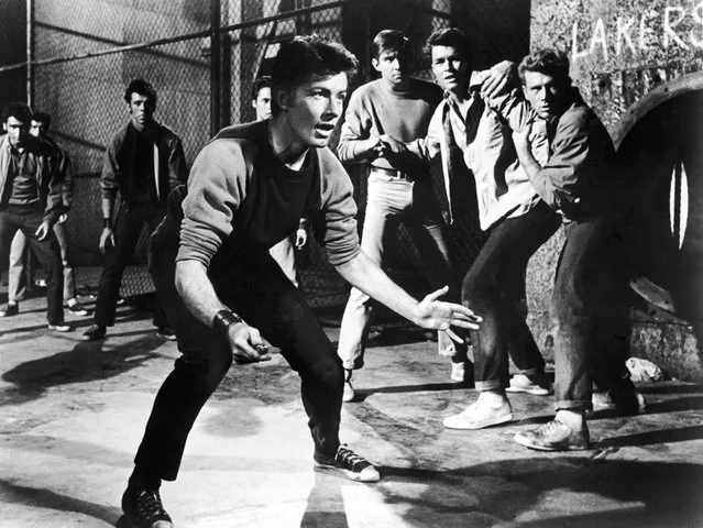 American actor George Chakiris holds a switchblade open, ready to fight a rival gang in a still from the musical film, “West Side Story”, directed by Jerome Robbins and Robert Wise, 1961. (Photo by United Artists/Courtesy of Getty Images)